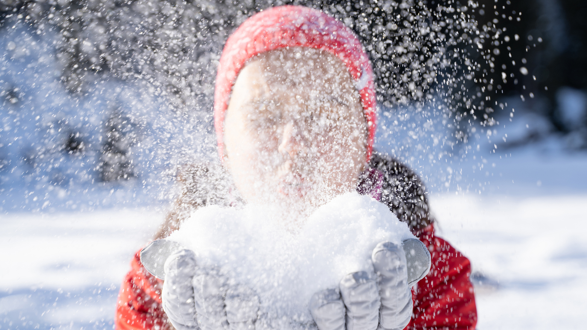 Woman In Winter Clothes Blowing Snow