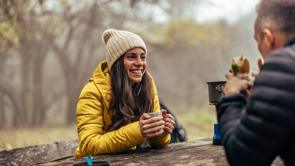 Smiling caucasian woman, spending time with her partner, in the woods.