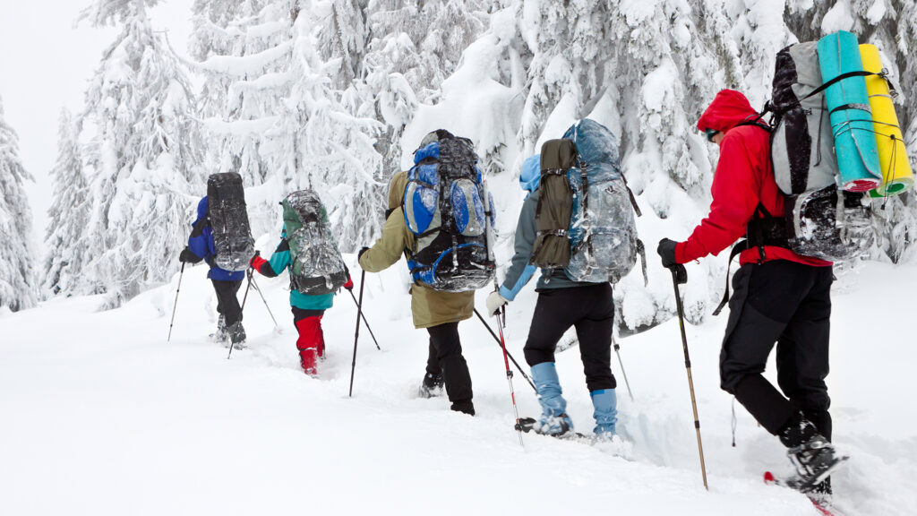 team of hikers in winter mountains